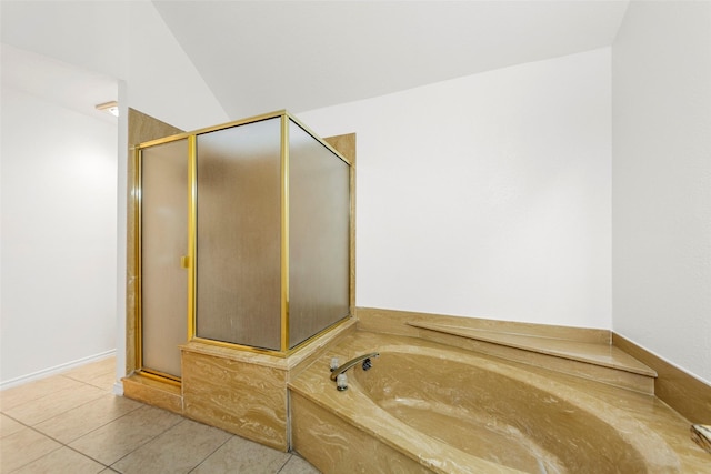 bathroom featuring tile patterned floors, a bath, and a shower stall