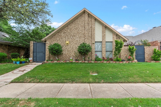 view of property exterior with a lawn, a gate, and brick siding