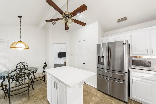 kitchen featuring white cabinets, lofted ceiling with beams, stainless steel appliances, a ceiling fan, and visible vents