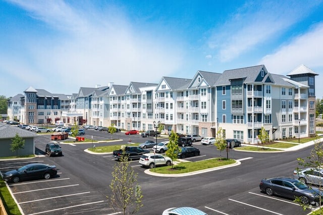 view of building exterior with uncovered parking
