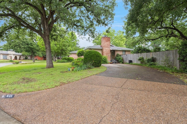 605 Clebud Dr, Euless, TX 76040 - view of front of home featuring a chimney and decorative driveway
