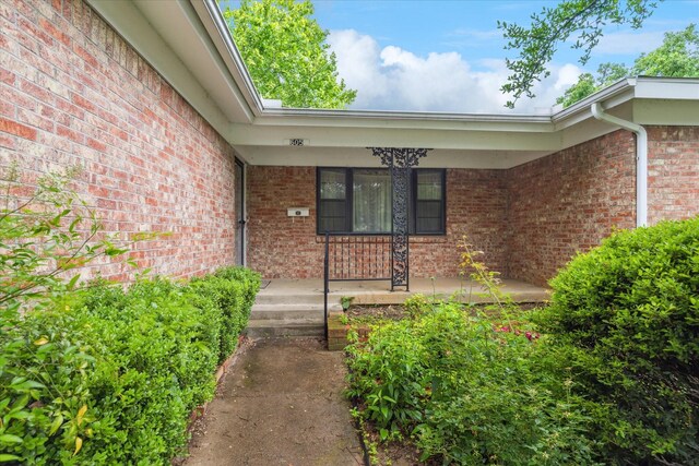 605 Clebud Dr, Euless, TX 76040 - doorway to property with brick siding and a porch