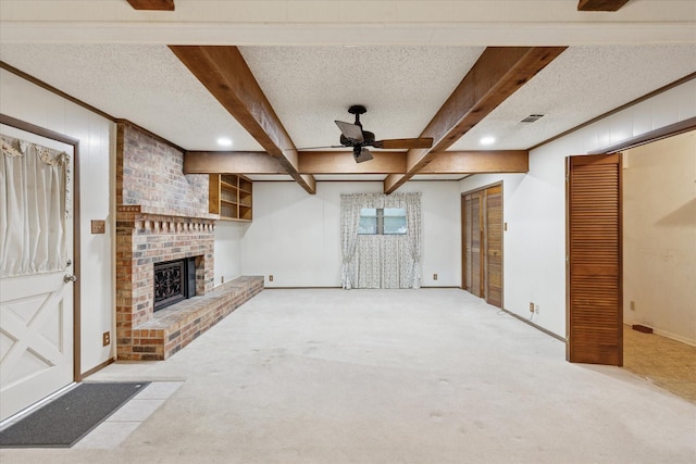 605 Clebud Dr, Euless, TX 76040 - unfurnished living room with carpet flooring, ceiling fan, a brick fireplace, beam ceiling, and a textured ceiling