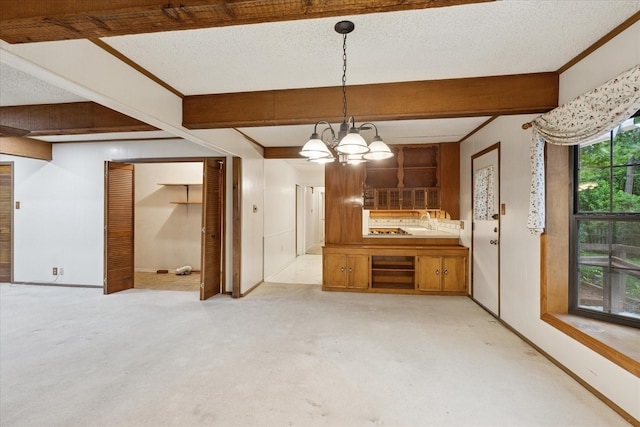 605 Clebud Dr, Euless, TX 76040 - unfurnished dining area with a chandelier, baseboards, and beam ceiling