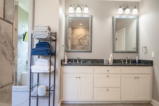 full bathroom with double vanity, a sink, and ornamental molding