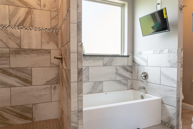 full bath featuring toilet, tiled shower, and a bathtub