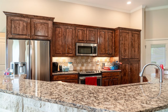 kitchen with crown molding, light stone counters, a sink, stainless steel appliances, and tasteful backsplash