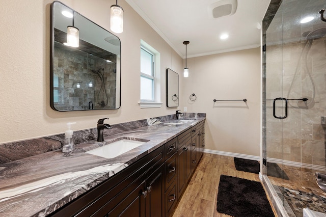 1823 E Cedar Elm Dr, Arlington, TX 76012 - bathroom featuring ornamental molding, a shower stall, a sink, and wood finished floors