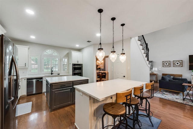 kitchen featuring a center island, dark wood-type flooring, and appliances with stainless steel finishes