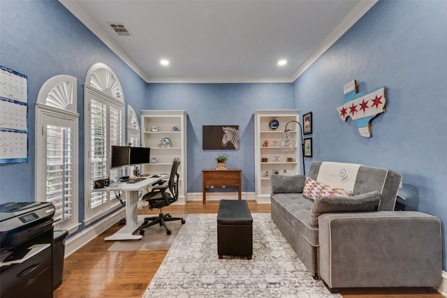 office space with visible vents, crown molding, wood finished floors, baseboards, and recessed lighting