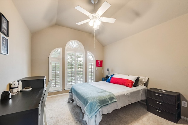 bedroom with baseboards, vaulted ceiling, light carpet, and ceiling fan