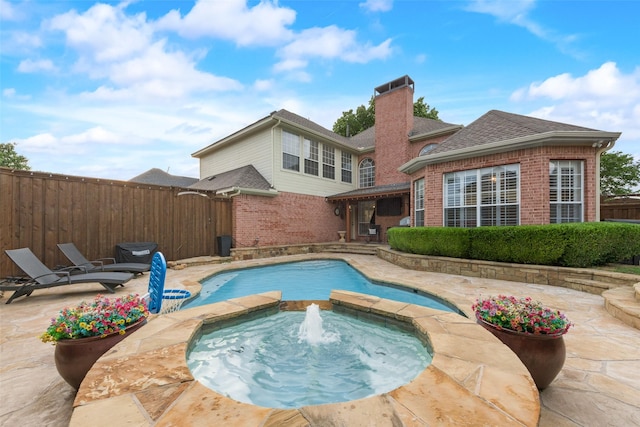 view of swimming pool featuring a patio, an in ground hot tub, fence, and a fenced in pool