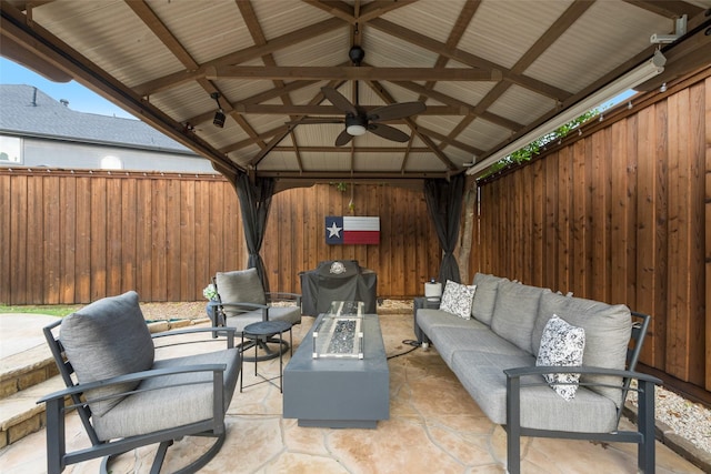 view of patio / terrace with fence, an outdoor living space with a fire pit, a gazebo, and grilling area