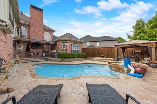 view of swimming pool featuring a gazebo, a fenced backyard, a pool with connected hot tub, and a patio