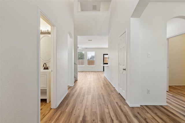 4413 Blackberry Rd, Melissa, TX 75454 - hall featuring arched walkways, light wood-type flooring, baseboards, and a sink