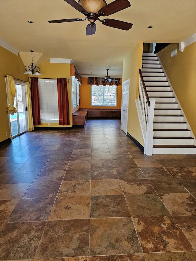 unfurnished living room featuring baseboards, ornamental molding, a wealth of natural light, and stairway