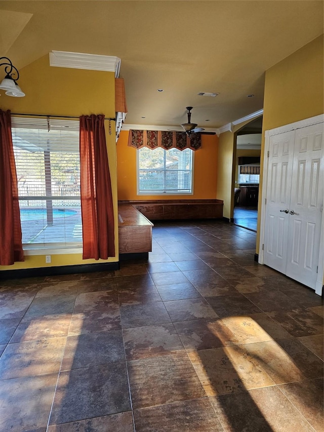 interior space with ceiling fan and visible vents