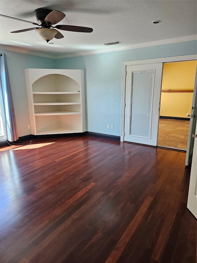 interior space with crown molding, visible vents, dark wood-type flooring, a textured ceiling, and a ceiling fan