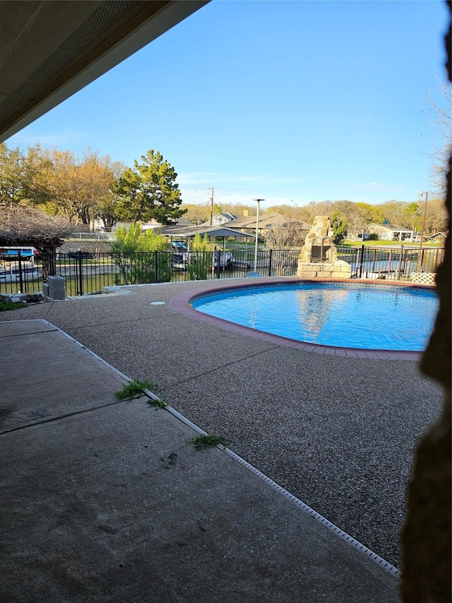 view of pool featuring a fenced in pool, fence, and a patio area