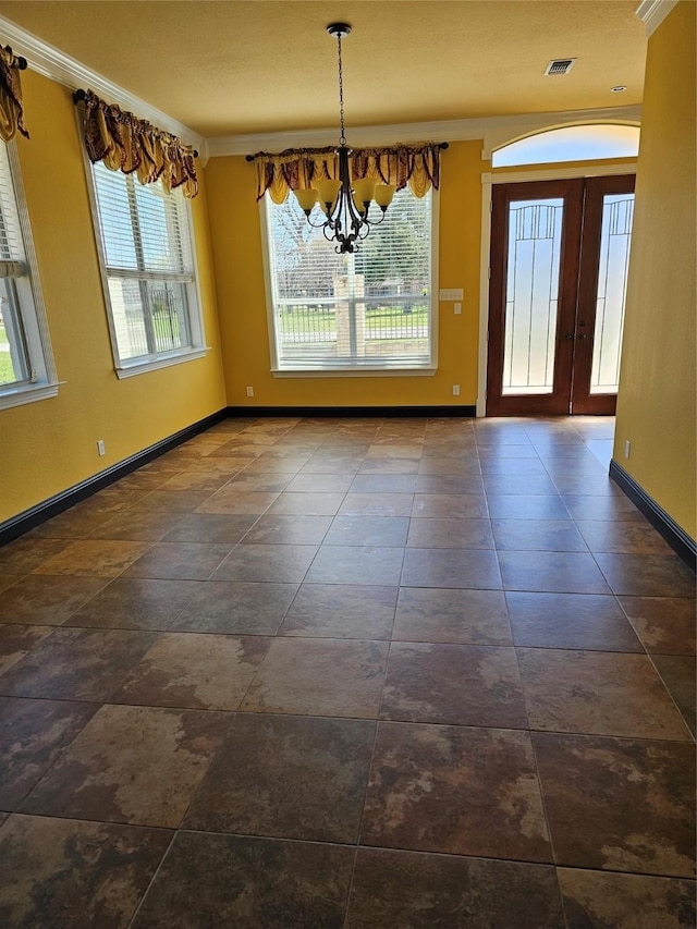 unfurnished dining area featuring visible vents, baseboards, a notable chandelier, and a healthy amount of sunlight