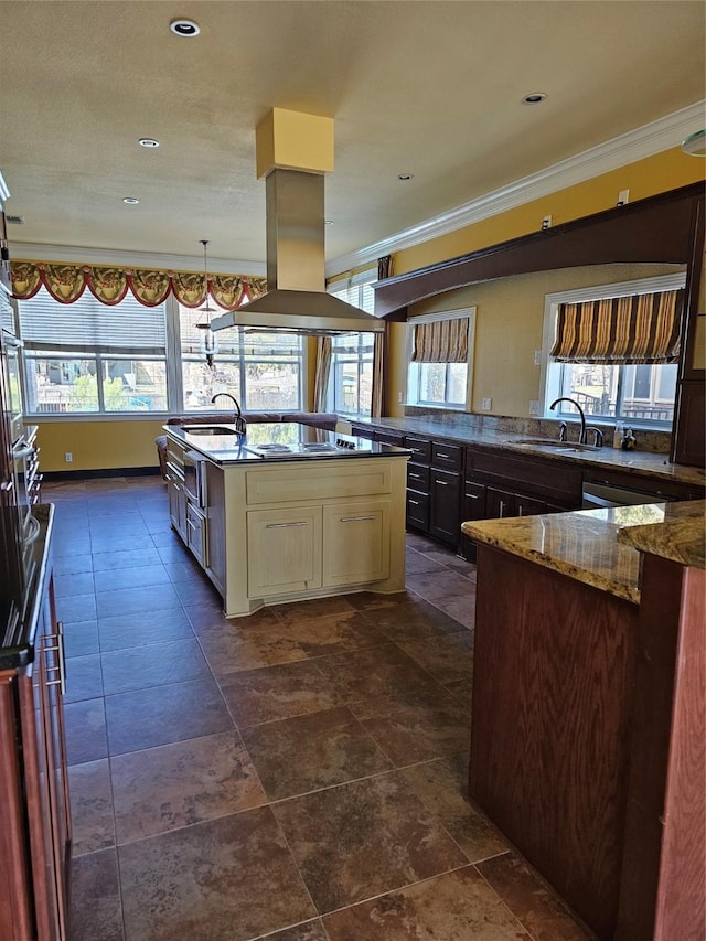 kitchen with island exhaust hood, a sink, stone counters, and a kitchen island with sink
