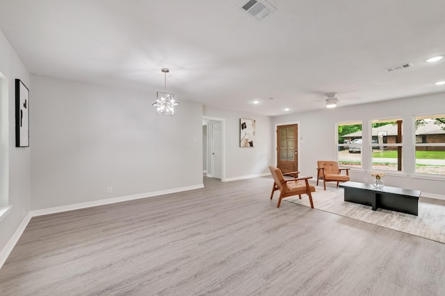 living area featuring recessed lighting, baseboards, visible vents, and wood finished floors
