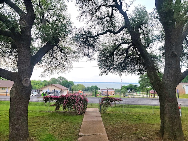 surrounding community featuring a lawn and fence