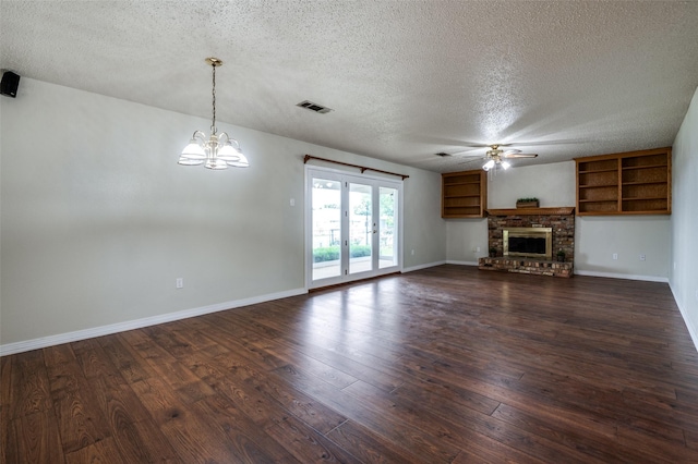 unfurnished living room featuring visible vents, baseboards, a textured ceiling, dark wood finished floors, and ceiling fan with notable chandelier