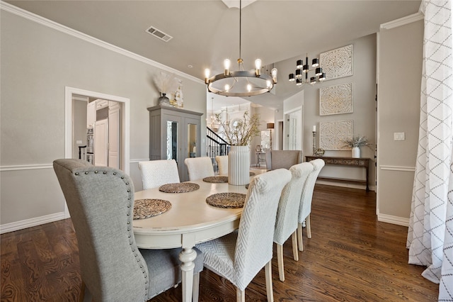 dining room featuring visible vents, baseboards, wood finished floors, and a notable chandelier