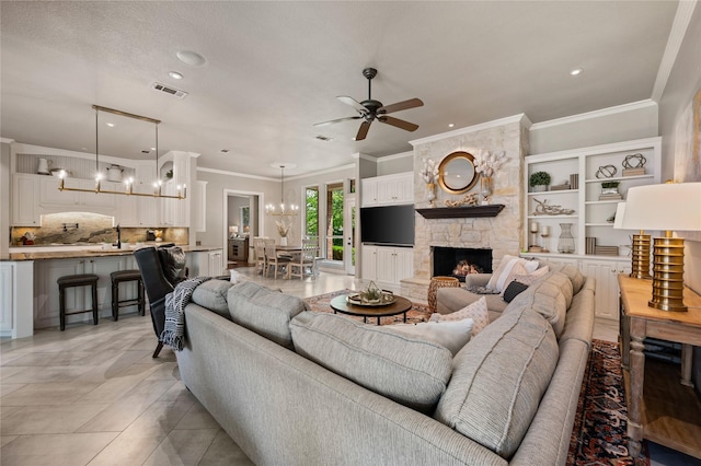 living area with ornamental molding, ceiling fan with notable chandelier, recessed lighting, and visible vents