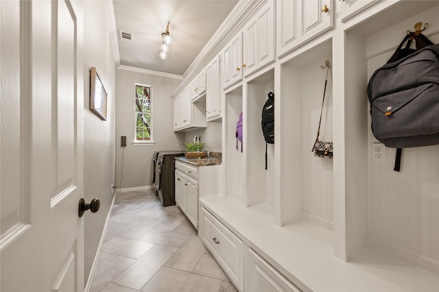 mudroom featuring crown molding, baseboards, and visible vents