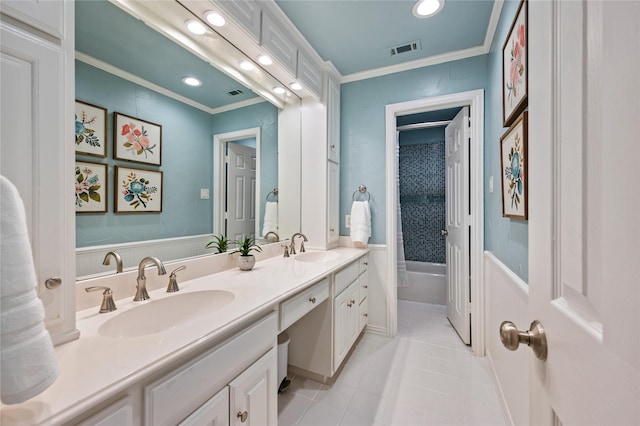 full bath with a sink, tile patterned floors, and crown molding