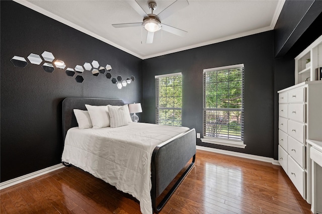 bedroom featuring crown molding, baseboards, ceiling fan, and wood-type flooring