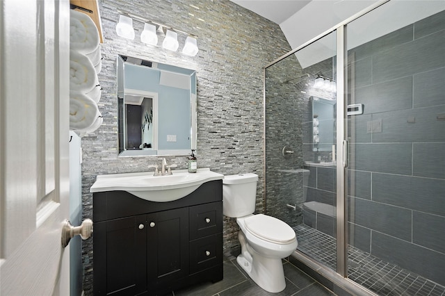 bathroom with vanity, toilet, tile patterned floors, and a stall shower