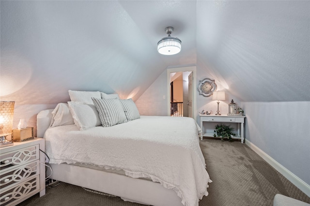 carpeted bedroom featuring baseboards and vaulted ceiling