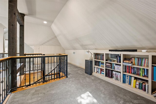 interior space featuring baseboards, carpet, and lofted ceiling
