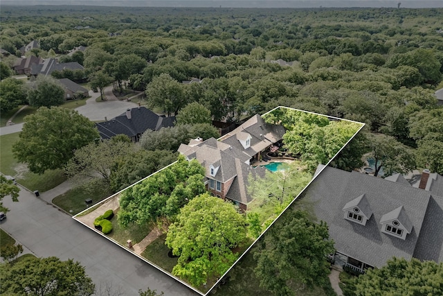 birds eye view of property with a residential view and a forest view
