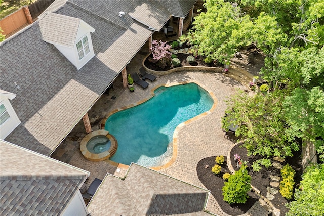 view of pool with a patio area and a pool with connected hot tub