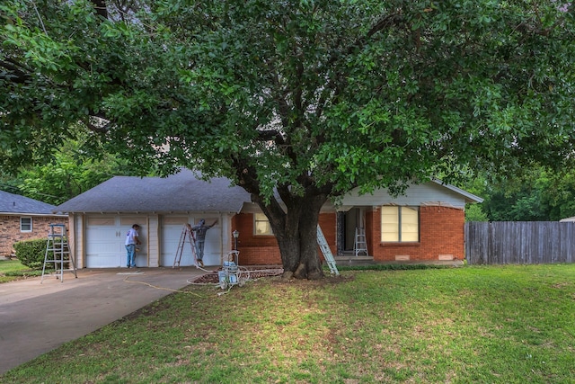 ranch-style house with a front lawn, fence, brick siding, crawl space, and driveway