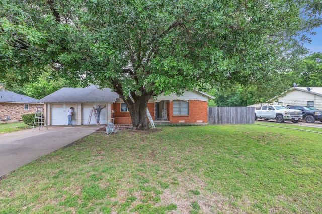 view of front of property with brick siding, fence, driveway, and a front lawn