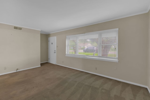 carpeted spare room with visible vents, ornamental molding, and baseboards