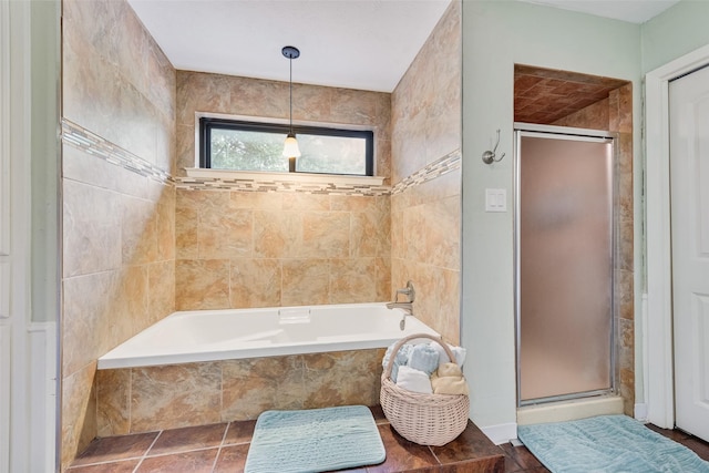 bathroom featuring a shower stall and a garden tub