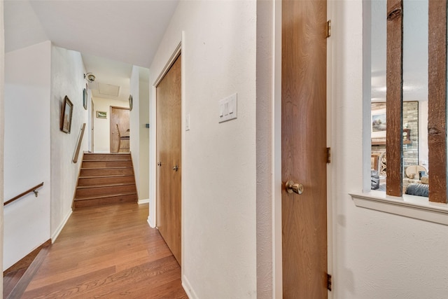 hallway with baseboards and light wood finished floors