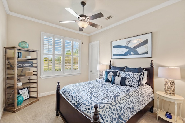 carpeted bedroom featuring baseboards, crown molding, and ceiling fan