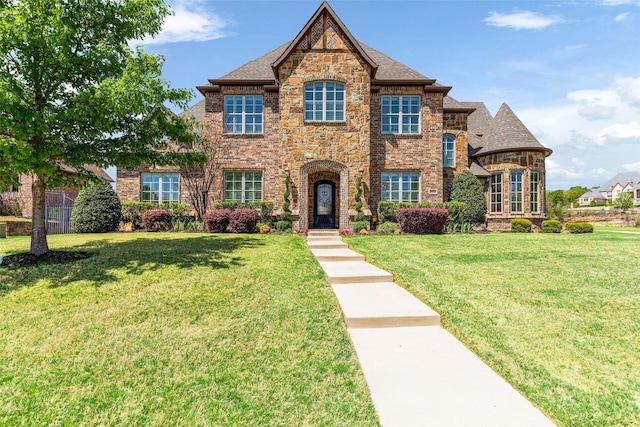view of front of home with a front yard and brick siding