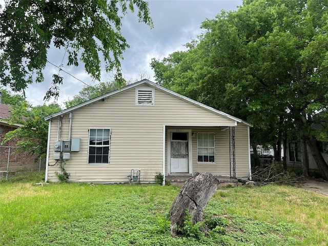 rear view of house featuring a yard