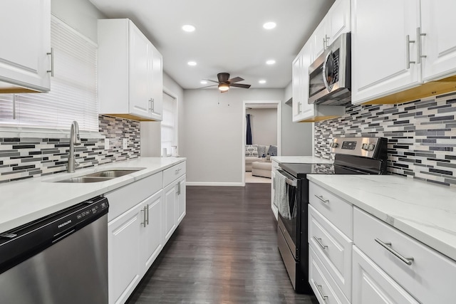 5636 Everglade Rd, Dallas, TX 75227 - kitchen featuring dark wood-style flooring, a sink, stainless steel appliances, baseboards, and recessed lighting