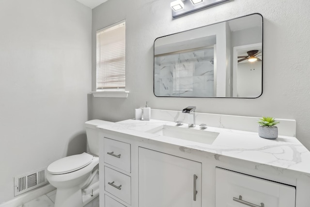 5636 Everglade Rd, Dallas, TX 75227 - bathroom with visible vents, vanity, marble finish floor, toilet, and a ceiling fan