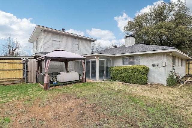 5636 Everglade Rd, Dallas, TX 75227 - back of property featuring a chimney, brick siding, a sunroom, a gazebo, and a yard