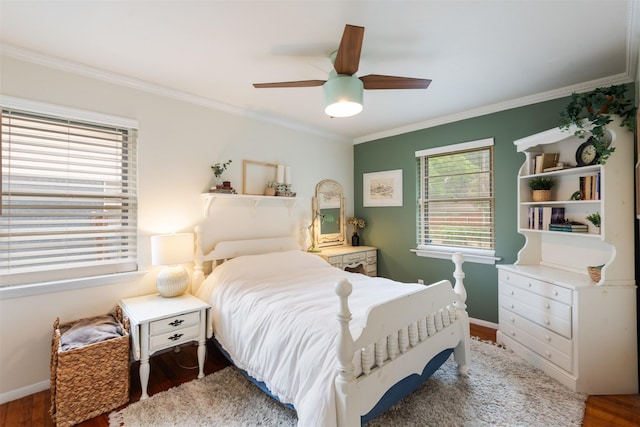 bedroom with crown molding, baseboards, and wood finished floors